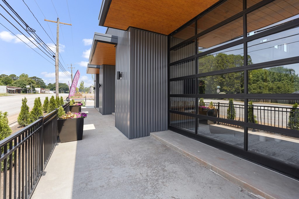 A modern building with a balcony and a flag.