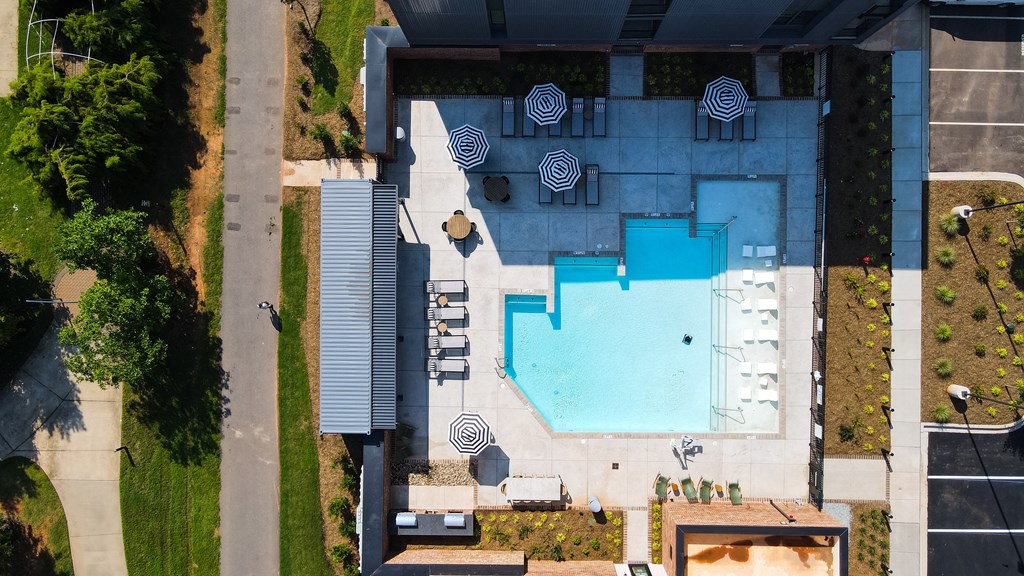 A swimming pool is located in the middle of a house.