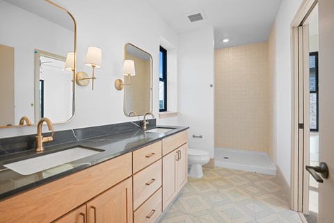 A bathroom with a sink, mirror, and toilet.