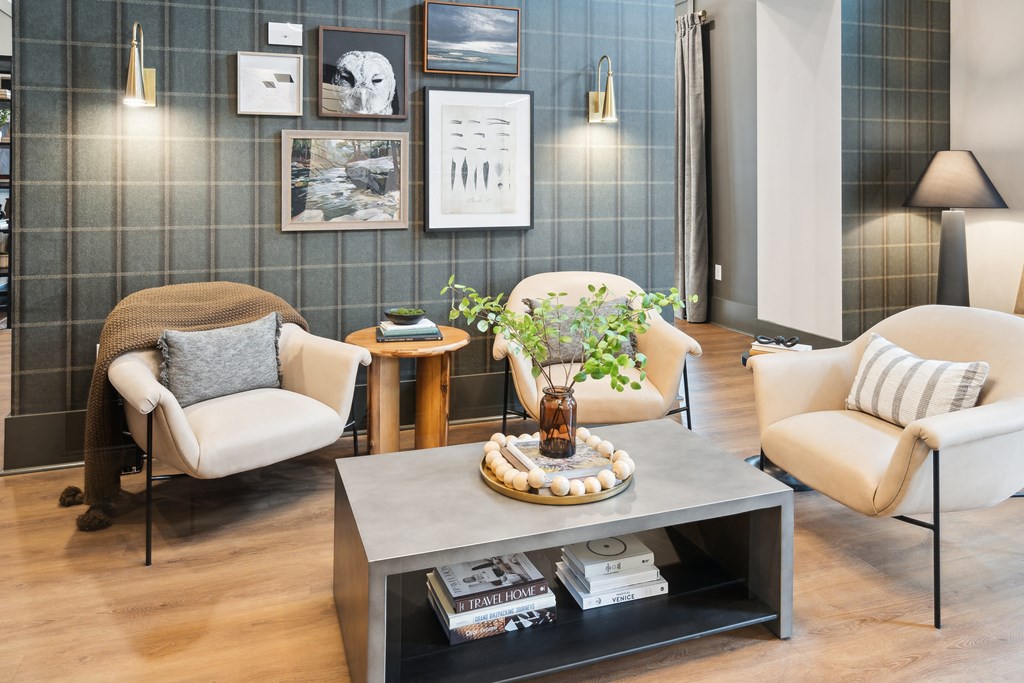 a living room with white chairs and a coffee table