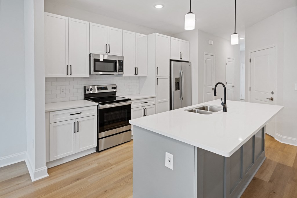 a kitchen with white cabinets and a white counter top