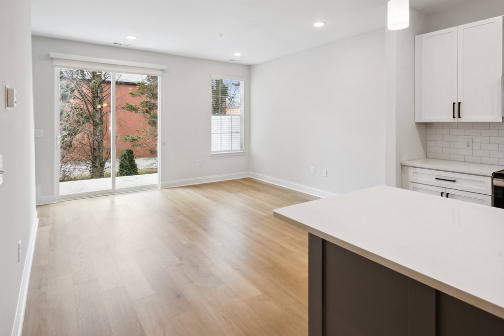 an empty kitchen and living room with a large window