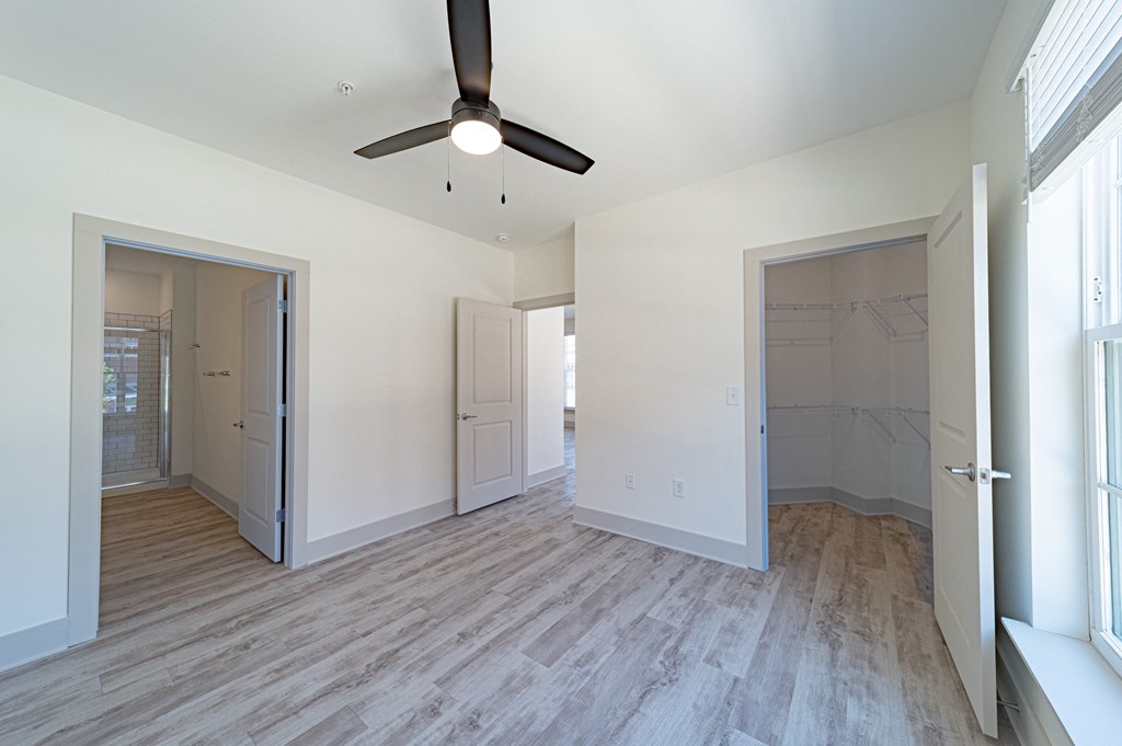 a bedroom with a closet and a ceiling fan