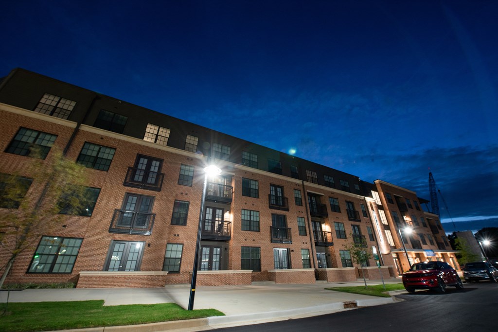 a large brick building at night with street lights