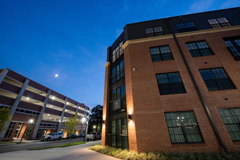 a building at night with the moon in the sky