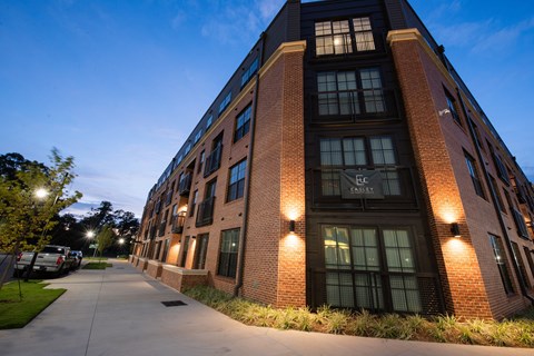 a large brick building at night with street lights