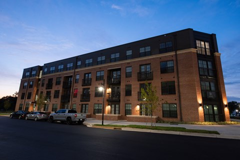 a large brick building with cars parked in front of it