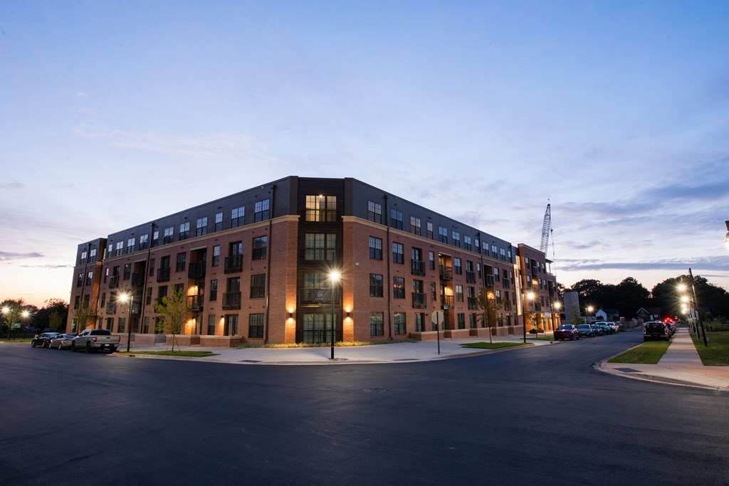 a large brick building at night with street lights