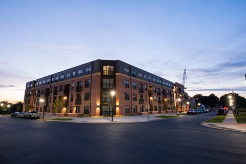 a large brick building at night with street lights