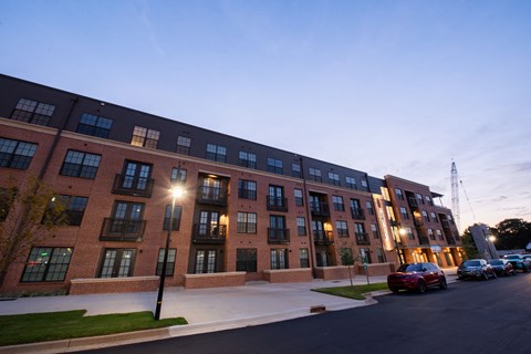 a large brick building with cars parked in front of it
