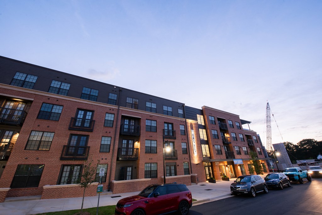 a large brick building with cars parked in front of it