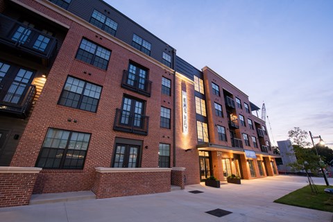 a large brick building with a sidewalk in front of it