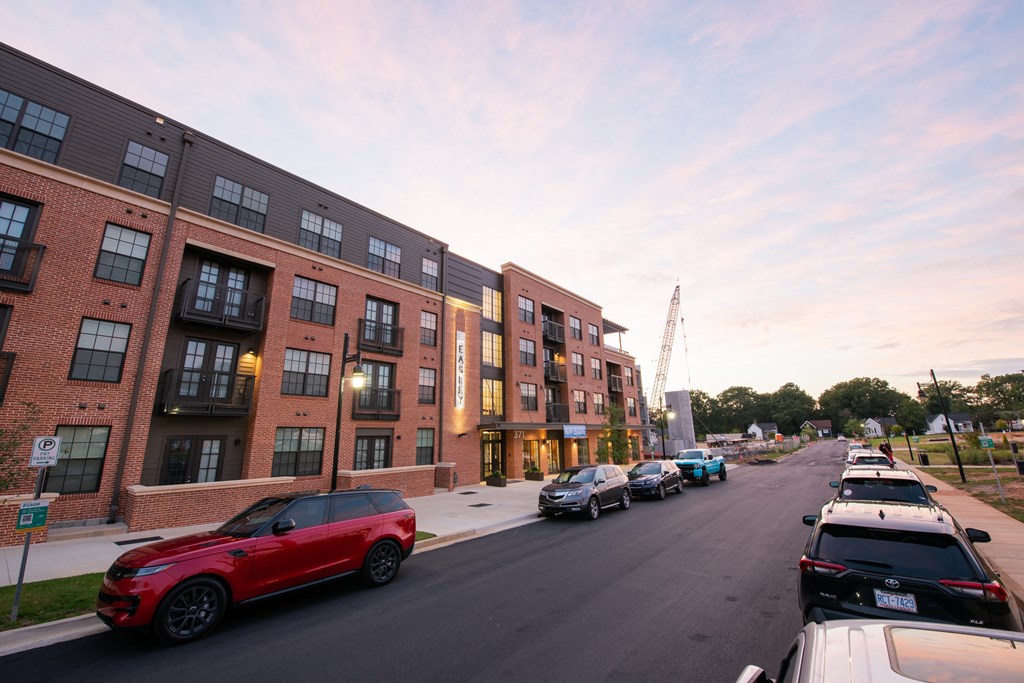 a city street with cars parked in front of a building