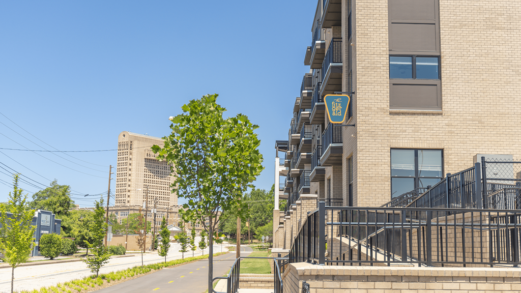 a brick building with a tree in front of it at The Fitzgerald, Spartanburg, 29302