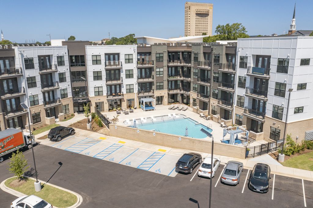 an aerial view of a large swimming pool in front of an apartment building at The Fitzgerald, Spartanburg