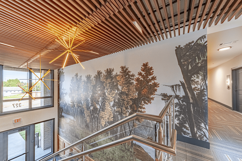 a large mural of a forest is on the wall of the stairwell at The Fitzgerald, Spartanburg, SC, 29302