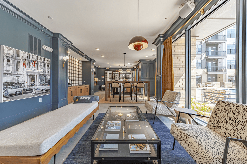 a living room with blue walls and a glass coffee table at The Fitzgerald, Spartanburg, SC