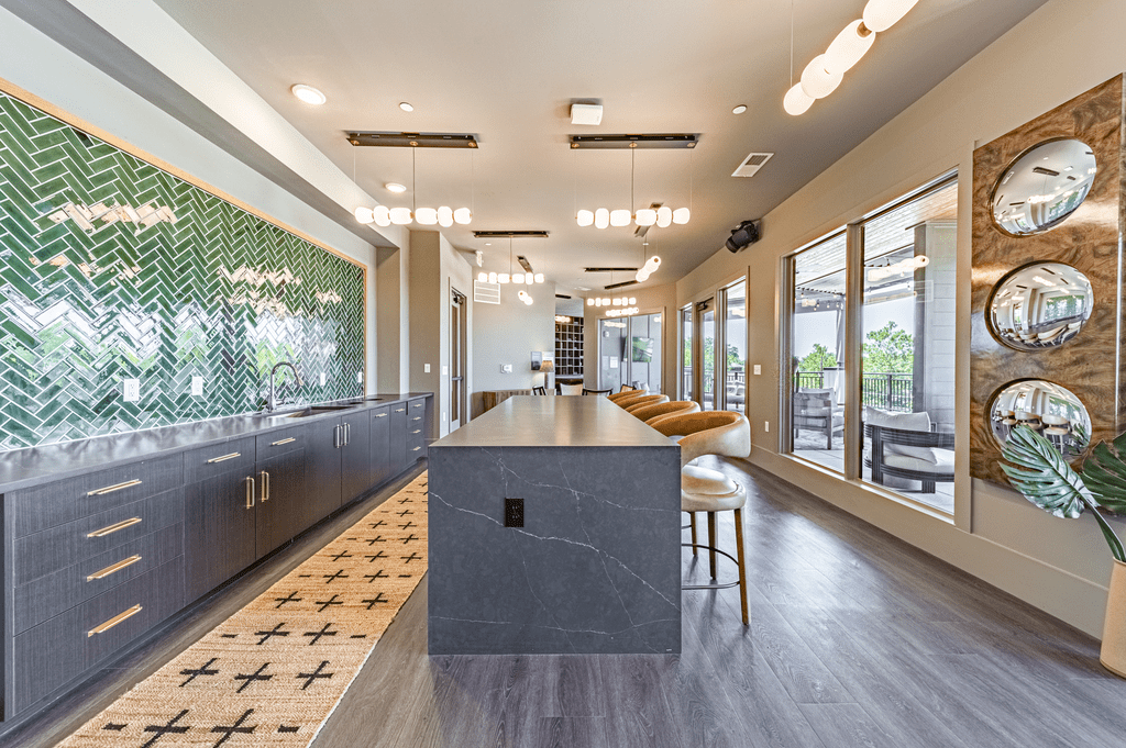 a kitchen with a long counter and a wall of windows at The Fitzgerald, South Carolina, 29302
