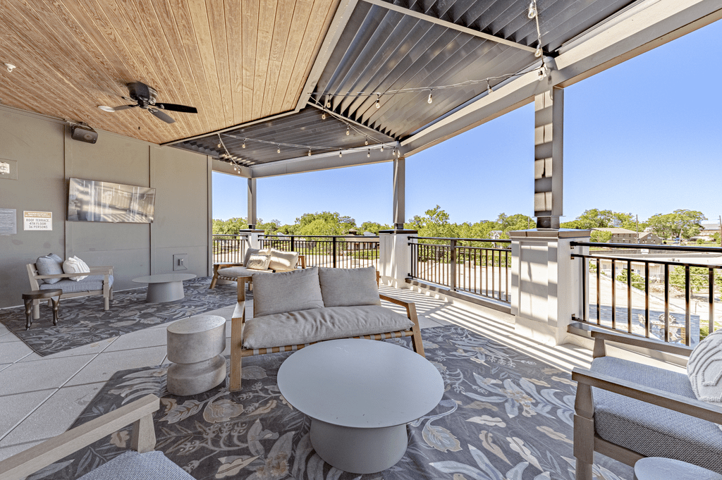 a covered patio with furniture and a view of a body of water at The Fitzgerald, Spartanburg, SC