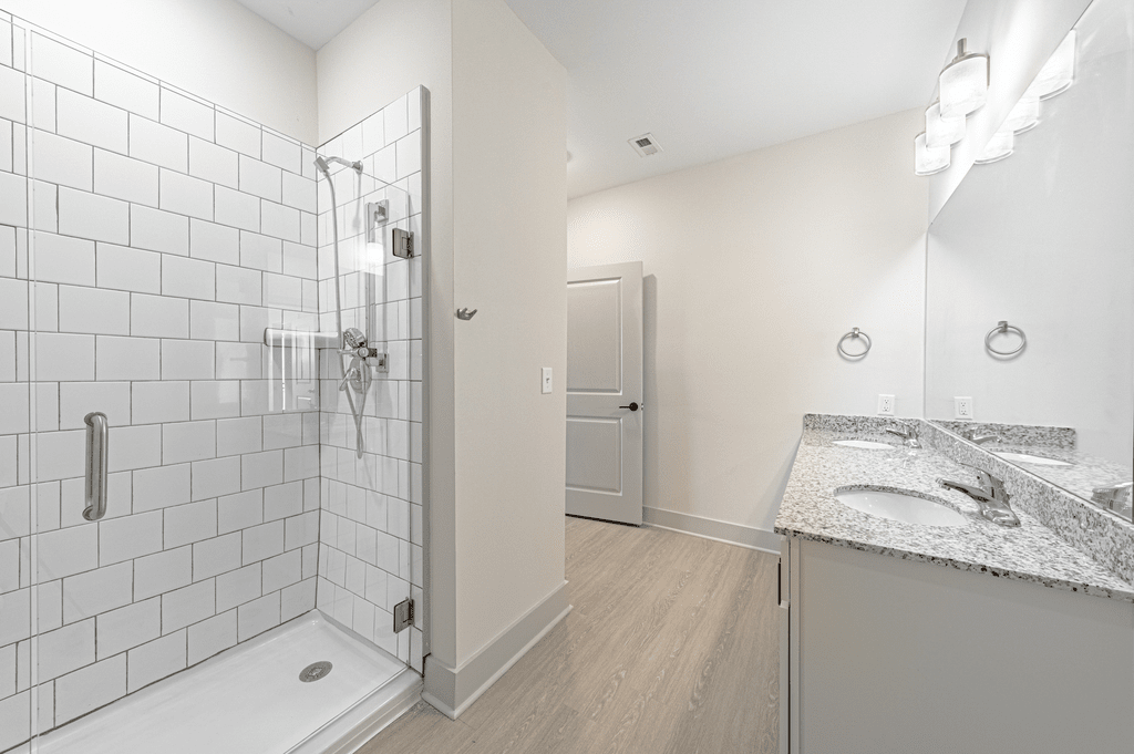 a bathroom with a shower and a sink at The Fitzgerald, Spartanburg, SC, 29302