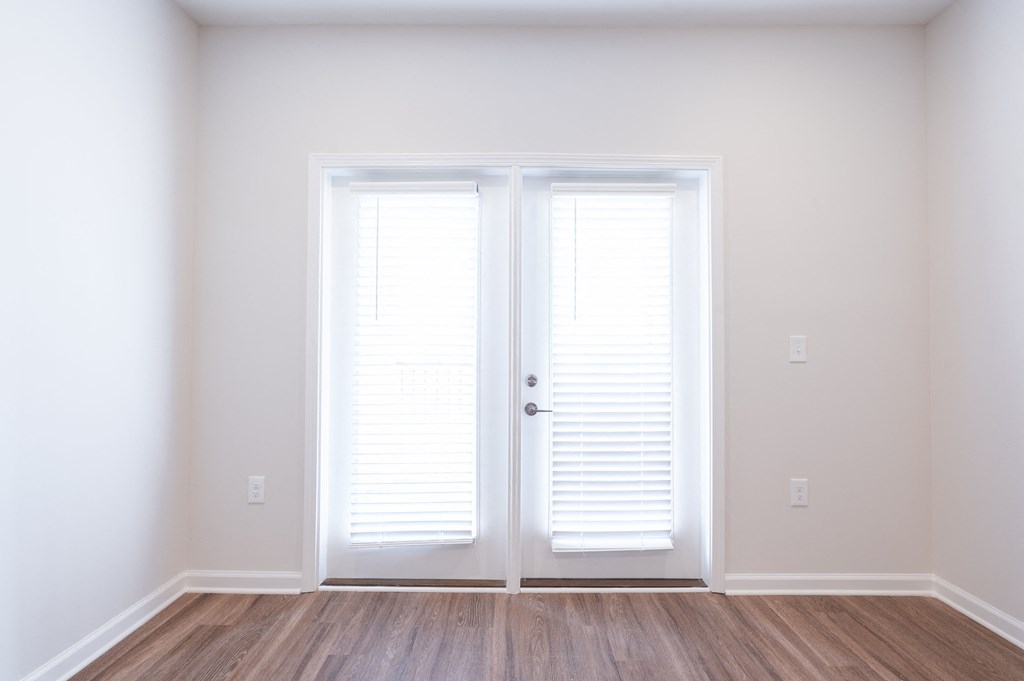 an empty living room with white walls and white doorsat Hamilton Reserve, Greensboro
