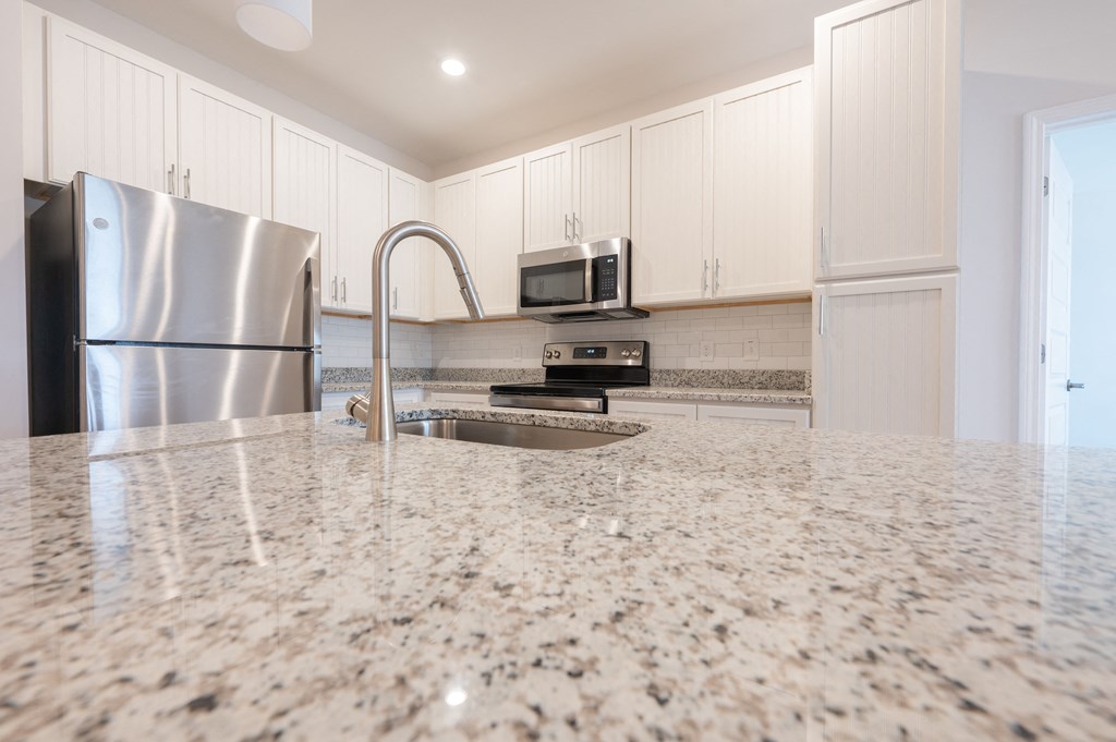 a kitchen with a granite counter top and a stainless steel refrigeratorat Hamilton Reserve, North Carolina