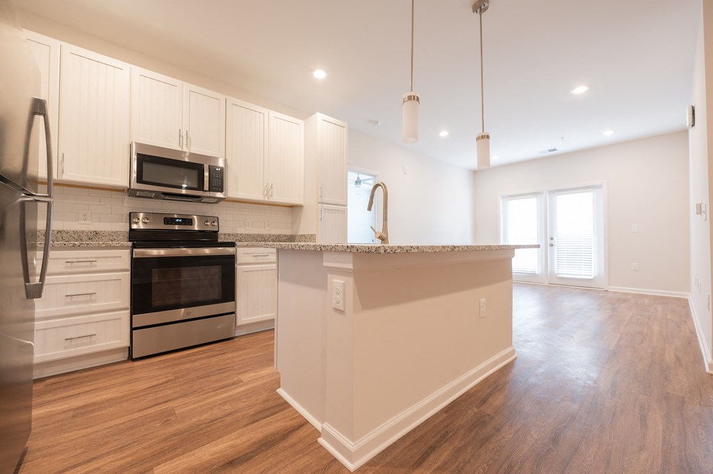 a kitchen with white cabinets and a large counter top at Hamilton Reserve, Greensboro North Carolina