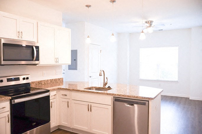 a kitchen with white cabinets and a counter top