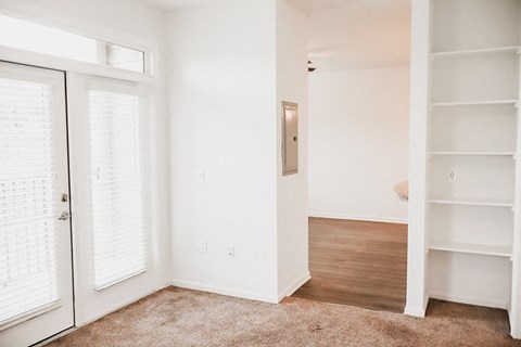 a bedroom with white walls and a closet with white doors