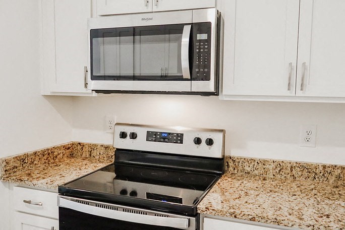 a kitchen with a stove and a microwave