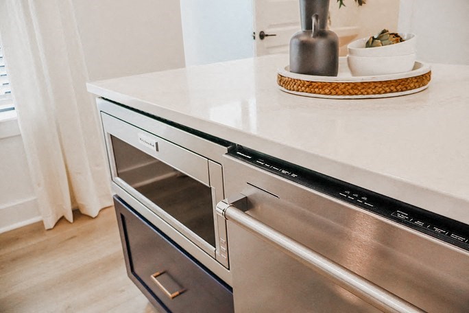 a kitchen with stainless steel appliances and a white counter top