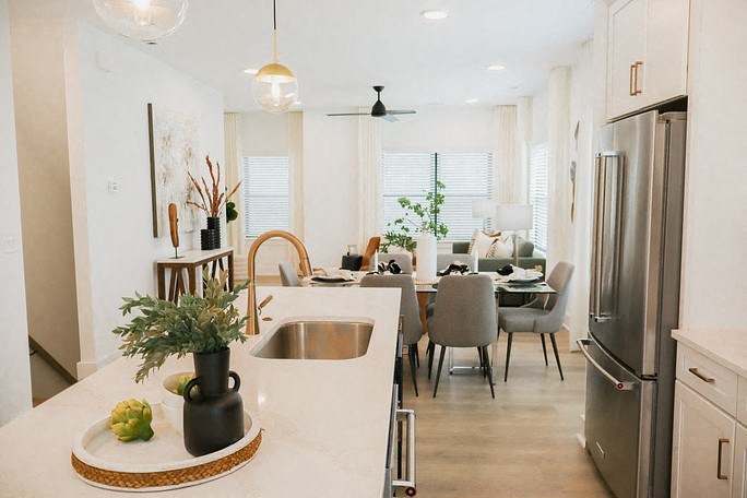 a kitchen and dining room with a table and a sink