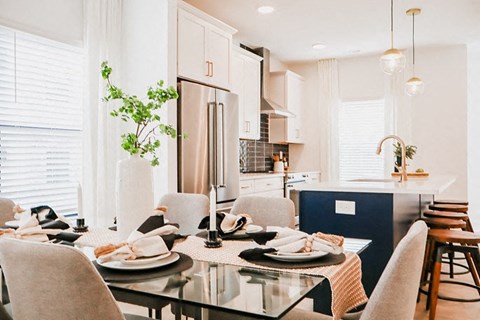 a kitchen and dining room with a table and chairs