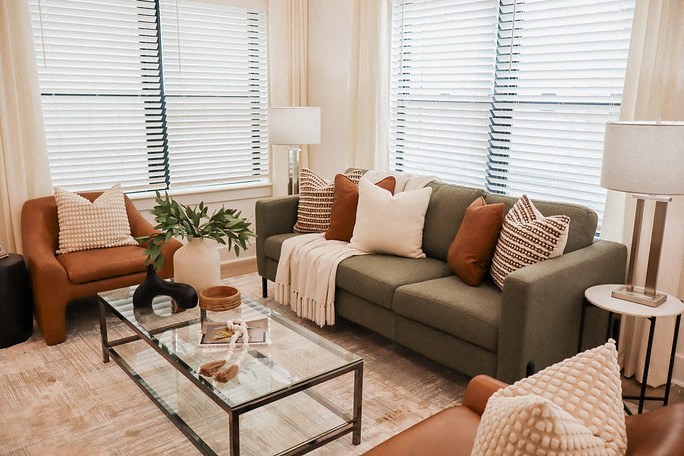 a living room with a couch and a glass coffee table