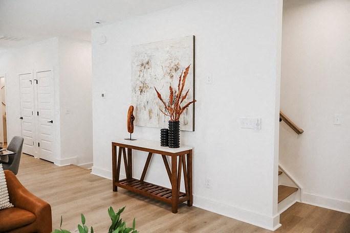a living room with a table and a painting on the wall