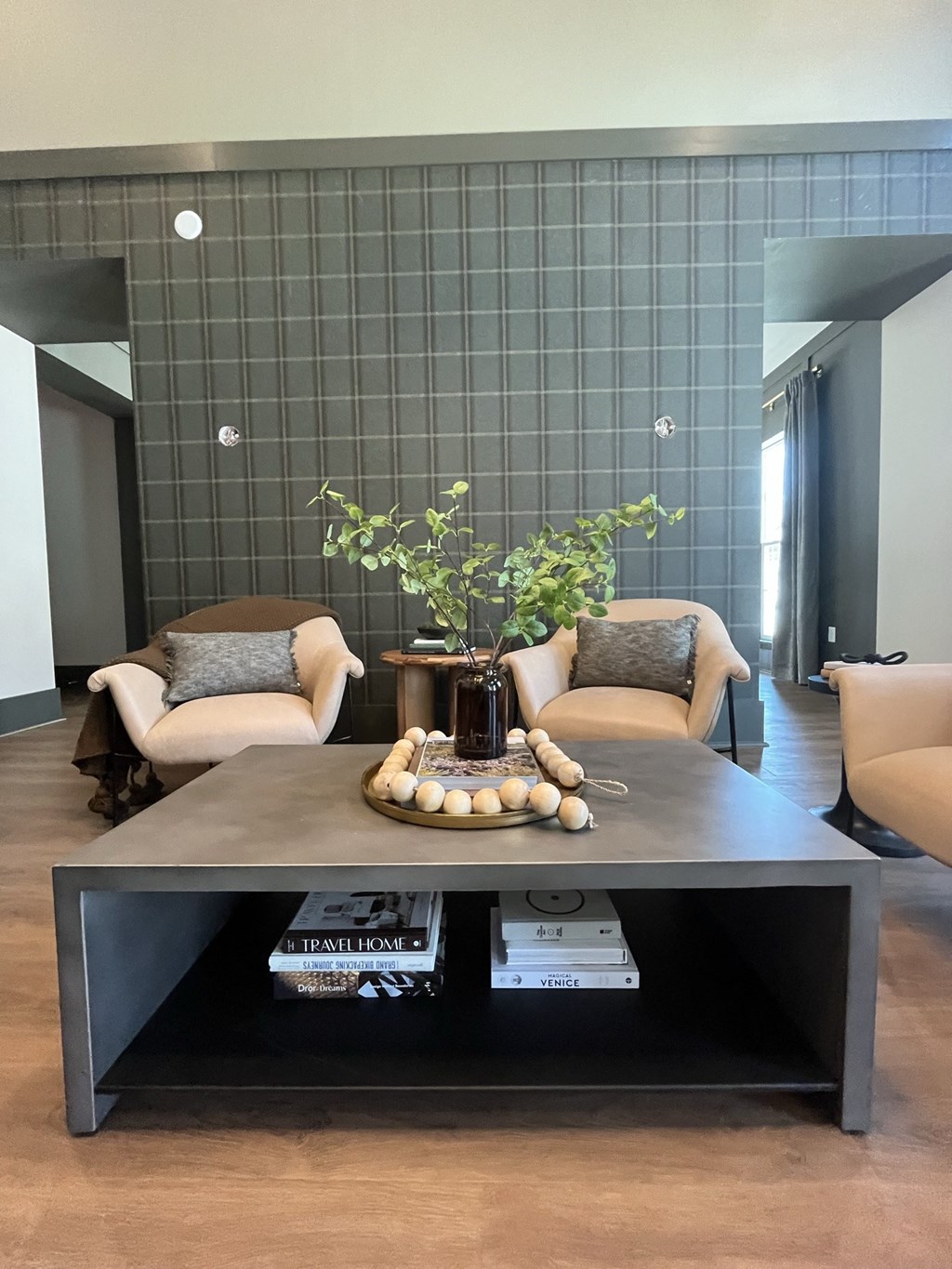 a living room with two chairs and a coffee table with a vase with a plant on at Landon Green Artisan Cottages Apartments, Hickory, North Carolina