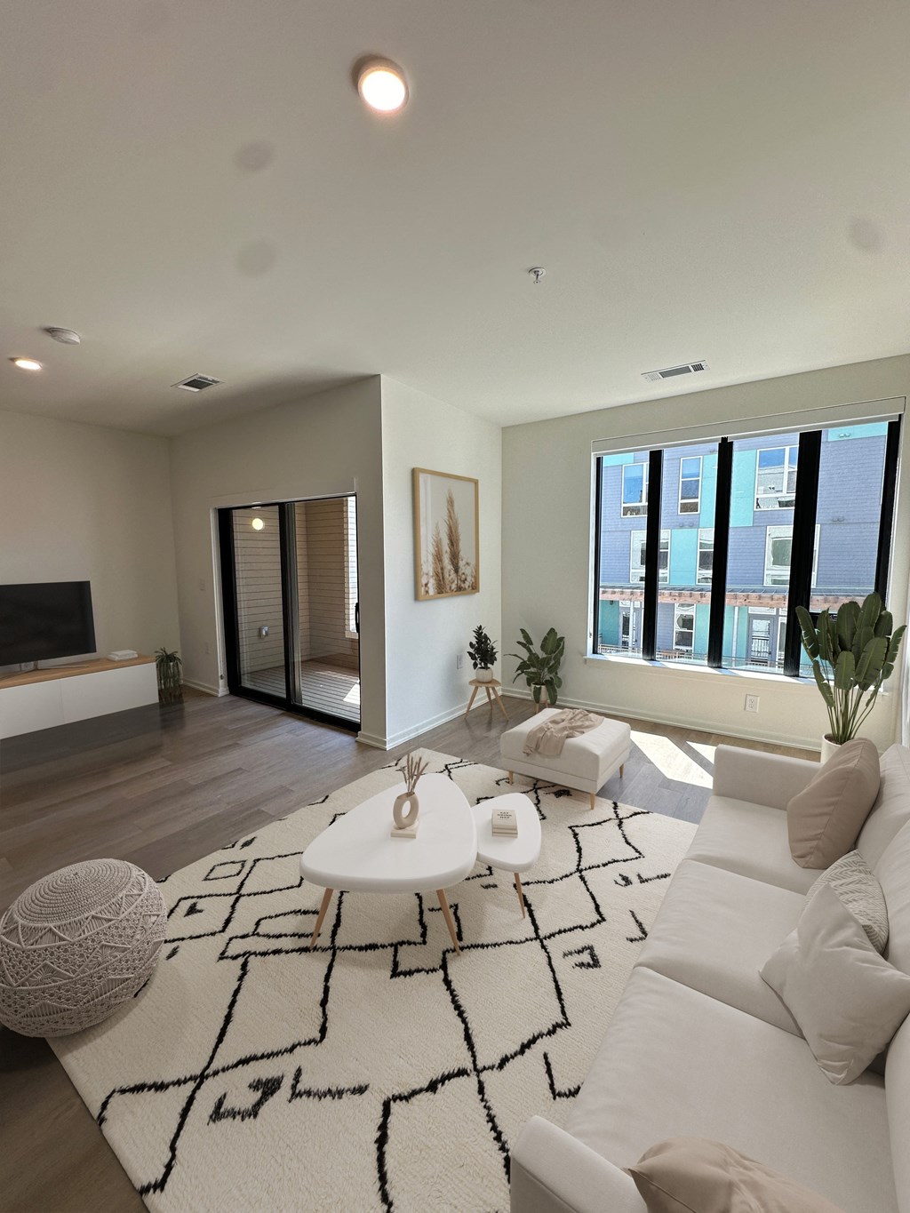 a white living room with a white rug and a white couch