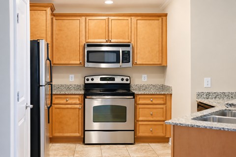 A kitchen with wooden cabinets and stainless steel appliances.