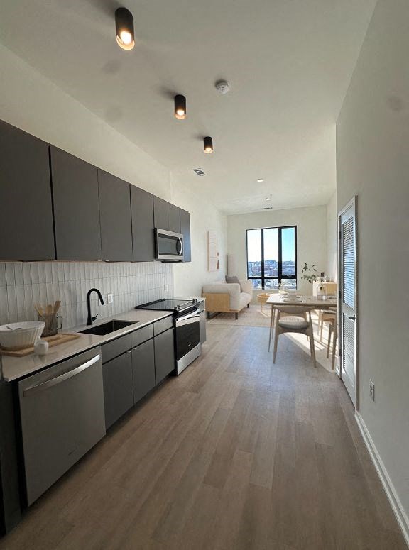 an empty kitchen and dining room with a table