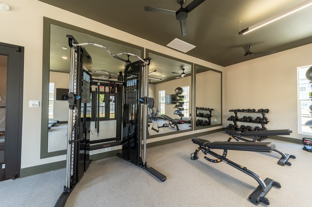 a home gym with exercise equipment and mirrors at Landon Green Artisan Cottages Apartments, Hickory, 28601