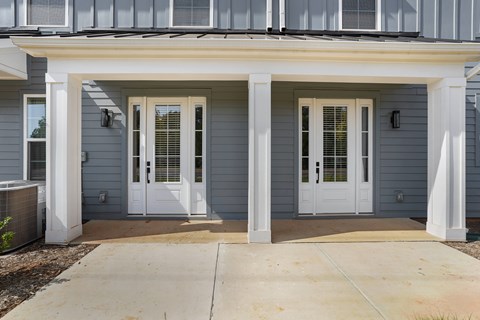 A house with a grey exterior and white trim.
