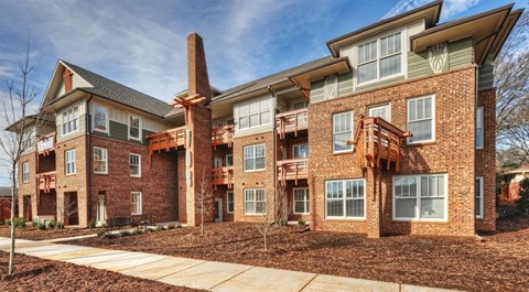 A large brick building with a balcony on the second floor.