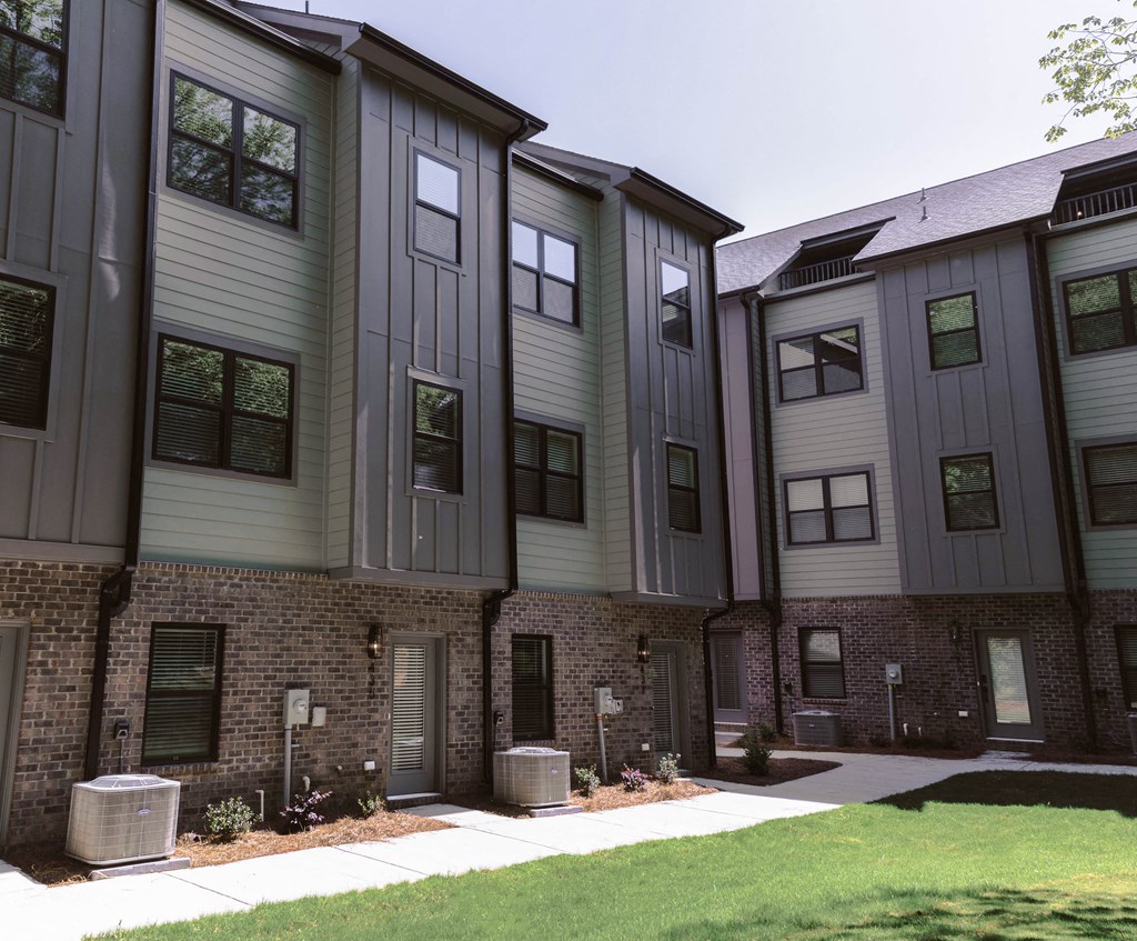 a row of townhomes with brick and gray buildings