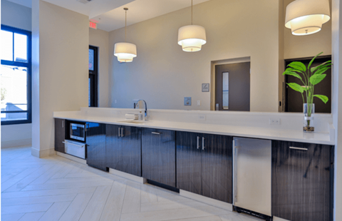 a large kitchen with a sink and a counter top