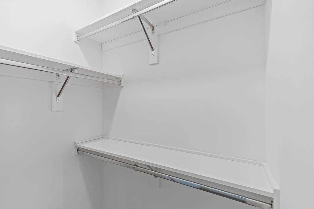 Empty white shelves in a room.