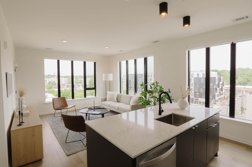 a living room with a kitchen and a couch and a table