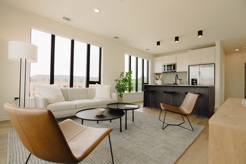 a living room with a couch and a table and a kitchen