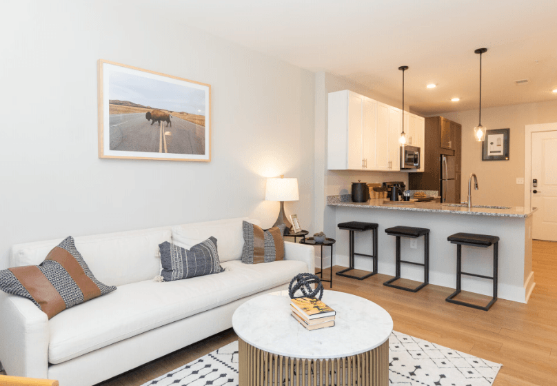 A living room with a white couch and a coffee table.