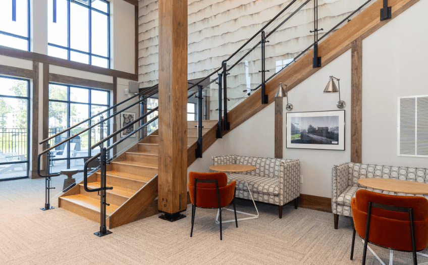 A staircase with a metal railing and wooden steps.