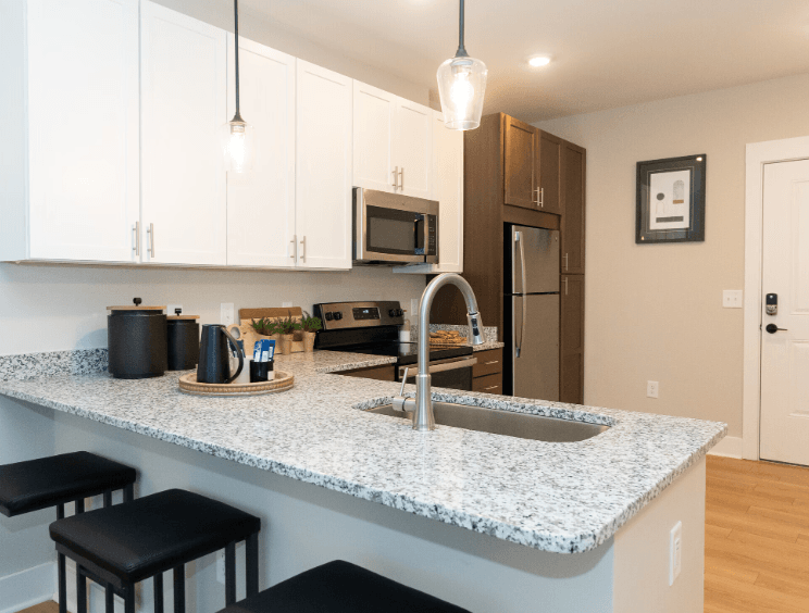 A kitchen with a granite countertop and a sink.